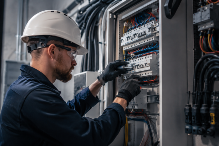 Commercial electrician installing electrical equipment in a commercial building